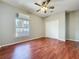 Bedroom with hardwood floors, closet, ceiling fan, and a window that provides natural light at 2150 Emperor Dr., Kissimmee, FL 34744