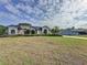 Spacious home featuring a beautiful front lawn and a driveway leading to a detached garage at 2150 Emperor Dr., Kissimmee, FL 34744