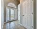 Elegant foyer with decorative front door, tiled flooring and an arched window above at 2150 Emperor Dr., Kissimmee, FL 34744
