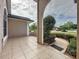 Inviting front porch with tiled flooring, decorative columns, and views of the landscaped yard at 2150 Emperor Dr., Kissimmee, FL 34744