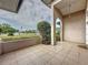 Charming front porch featuring decorative columns, tiled flooring, and a view of the neighborhood at 2150 Emperor Dr., Kissimmee, FL 34744