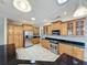 Kitchen featuring wood cabinets, granite counters, stainless appliances, and tile flooring at 2150 Emperor Dr., Kissimmee, FL 34744