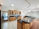 Kitchen featuring wood cabinetry, granite countertops, and stainless steel appliances at 2150 Emperor Dr., Kissimmee, FL 34744