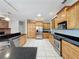 Spacious kitchen featuring tile flooring, granite countertops, and stainless steel appliances at 2150 Emperor Dr., Kissimmee, FL 34744