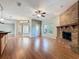 Open-concept living room with a brick fireplace, hardwood floors, and a view of the backyard at 2150 Emperor Dr., Kissimmee, FL 34744