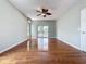 View of spacious living room featuring hardwood floors, fan, and access to the patio at 2150 Emperor Dr., Kissimmee, FL 34744