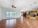 Spacious living room with hardwood floors, a ceiling fan, and an open view of the kitchen at 2150 Emperor Dr., Kissimmee, FL 34744
