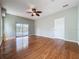 View of spacious living room featuring hardwood floors, fan, and access to the patio at 2150 Emperor Dr., Kissimmee, FL 34744