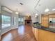 Open living space with kitchen island, brick fireplace, and views of the pool at 2150 Emperor Dr., Kissimmee, FL 34744