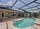 Outdoor pool surrounded by a screened enclosure and views of the home and backyard at 2150 Emperor Dr., Kissimmee, FL 34744