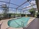 Screened-in pool with beautiful clear water and lakeside view for relaxing or entertaining at 2150 Emperor Dr., Kissimmee, FL 34744