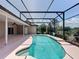 Outdoor pool surrounded by a screened enclosure, views of the backyard and lake at 2150 Emperor Dr., Kissimmee, FL 34744