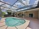 Inviting screened pool with ceiling fans offering backyard relaxation and fun at 2150 Emperor Dr., Kissimmee, FL 34744