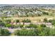 High aerial view of a meticulously landscaped golf course community with homes surrounded by lush greenery and mature trees at 2473 Saint Augustine Blvd, Haines City, FL 33844