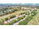 Scenic aerial view of a community situated on a lush golf course with mature trees and well-kept homes under a blue sky at 2473 Saint Augustine Blvd, Haines City, FL 33844