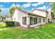 Lawn view of back exterior with lanai, screen room and well maintained lawn at 2473 Saint Augustine Blvd, Haines City, FL 33844