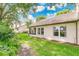 Back of the home with patio, green lawn and large windows letting in natural light at 2473 Saint Augustine Blvd, Haines City, FL 33844