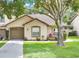 Charming home features a well-manicured lawn, beautiful landscaping, and inviting curb appeal at 2473 Saint Augustine Blvd, Haines City, FL 33844