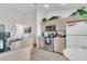 Well-lit kitchen showing neutral cabinets, tiled floors, and modern appliances at 2473 Saint Augustine Blvd, Haines City, FL 33844