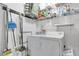 Functional laundry room features washer, dryer, shelving, and essential cleaning supplies at 2473 Saint Augustine Blvd, Haines City, FL 33844