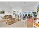 Bright living room with neutral carpet, adjacent to the kitchen and dining area at 2473 Saint Augustine Blvd, Haines City, FL 33844
