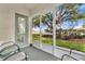 Cozy screened-in patio with chairs, offering a serene outdoor space with views of the well-maintained yard at 2473 Saint Augustine Blvd, Haines City, FL 33844