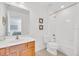 Bright bathroom featuring a tiled shower/tub combination, light wood vanity and modern fixtures at 2628 Tranquility Way, Kissimmee, FL 34746