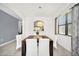 Dining room featuring a dark wood table, white chairs, and a decorative light fixture at 2628 Tranquility Way, Kissimmee, FL 34746