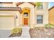 Charming home with a well-manicured lawn, arched entrance, and an elegant front door at 2628 Tranquility Way, Kissimmee, FL 34746