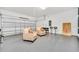 Spacious two-car garage featuring epoxy floors, seating area and game area at 2628 Tranquility Way, Kissimmee, FL 34746