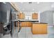 Well-equipped kitchen featuring stainless steel appliances, wood cabinets, and a breakfast bar at 2628 Tranquility Way, Kissimmee, FL 34746