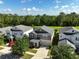 Aerial view featuring a two-story home and a lake in the distance at 3138 Dark Sky Dr, St Cloud, FL 34773