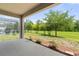 Covered back porch offering views of the screen enclosed pool and lush green backyard at 3138 Dark Sky Dr, St Cloud, FL 34773