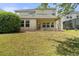 Backyard view with grass, patio, and screened-in pool at 3138 Dark Sky Dr, St Cloud, FL 34773