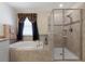 A luxurious bathroom features a soaking tub and a separate glass-enclosed shower at 3138 Dark Sky Dr, St Cloud, FL 34773