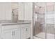 Bright bathroom features a glass shower with tiled walls and storage at 3138 Dark Sky Dr, St Cloud, FL 34773
