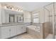 Bathroom displaying a double sink vanity, soaking tub, and walk-in shower at 3138 Dark Sky Dr, St Cloud, FL 34773