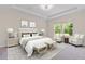 Cozy bedroom featuring two chairs, a king-size bed, two side tables, and lots of light at 3138 Dark Sky Dr, St Cloud, FL 34773