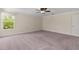 Spacious bedroom with natural light, featuring a fan and plush carpeting at 3138 Dark Sky Dr, St Cloud, FL 34773