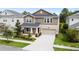 Two story home with an attached two car garage, lawn, and beautifully landscaped front yard at 3138 Dark Sky Dr, St Cloud, FL 34773
