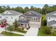 Two story home with an attached two car garage, lawn, and landscaped front yard at 3138 Dark Sky Dr, St Cloud, FL 34773