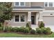 Close up of front porch with beautiful landscaping, updated front door, and stone accents at 3138 Dark Sky Dr, St Cloud, FL 34773