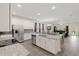 Gourmet kitchen with stainless steel appliances, white cabinets, granite counters and center island at 3138 Dark Sky Dr, St Cloud, FL 34773