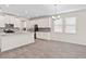Open concept kitchen with stainless appliances, white cabinets, and dining area at 3138 Dark Sky Dr, St Cloud, FL 34773