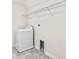 Laundry room features tile flooring, a washing machine, and a wire shelf for storage at 3138 Dark Sky Dr, St Cloud, FL 34773