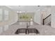 Open-concept living area with hardwood floors and view from the kitchen at 3138 Dark Sky Dr, St Cloud, FL 34773