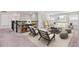 Open living room with two chairs, a bookshelf, couch, coffee table, and natural light from the windows at 3138 Dark Sky Dr, St Cloud, FL 34773