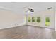 Bright living room with wood-look flooring, a ceiling fan, and sliding glass doors at 3138 Dark Sky Dr, St Cloud, FL 34773