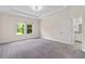 Bright main bedroom features neutral carpet, tray ceiling, ensuite bath and backyard views at 3138 Dark Sky Dr, St Cloud, FL 34773