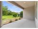 Covered outdoor patio with views of the manicured lawn and landscaping at 3138 Dark Sky Dr, St Cloud, FL 34773